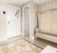 Cozy hallway with a stylish armchair and wallpaper in a 3-room apartment.