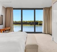 A bright bedroom with a view of the river offers a pleasant atmosphere in a 3-room apartment.