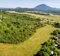 A meadow with a view of the hills, development plots, Prešov Kúty, bordered by a red line.