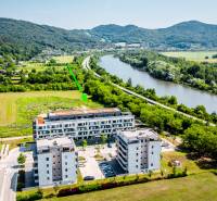 Aerial view of residential buildings on Dlhé lúky street in Púchov, surrounded by greenery.