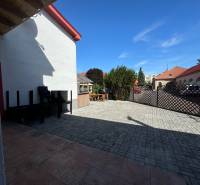 In the premises of the commercial spaces at Žerotínova Bašta in Nové Zámky, there is a paved area with furniture.