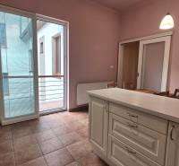 A kitchen with an island and balcony doors in a 5 or more room apartment.