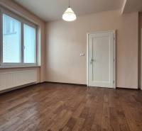 A room in a 5 or more room apartment with a wooden floor and a large window.