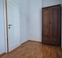 Interior in a 5 or more room apartment with wooden flooring and a dark wardrobe.