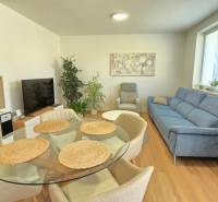 A bright living room in a family house with comfortable seating and a dining table.