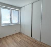 A room with a wooden floor and a built-in wardrobe in a family house.