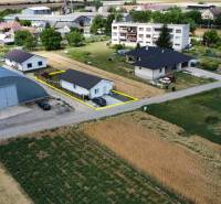 An aerial view of family houses in Nižná, surrounded by fields and buildings.