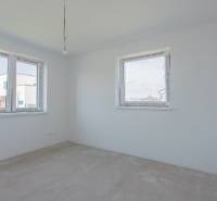 Empty room with white walls and windows, construction in a family house.