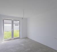 Empty room with white walls and glass doors in a family house.