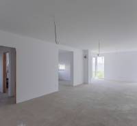 A spacious, bright room with windows in a family house and incomplete ceiling electrical installations.