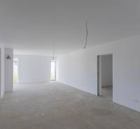 Bright, unfurnished room in a family house with white walls and ceiling.