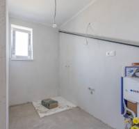 A partially finished bathroom in a family house with installation elements.
