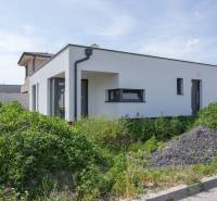 A family house in Zohor with a white facade and surrounding greenery.