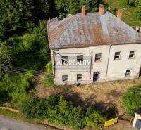 A building in Hodruša - Hámre surrounded by greenery, suitable for commercial spaces.
