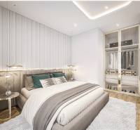 A bedroom in a 2-room apartment with a stylish bed and a built-in wardrobe.