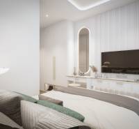 A bright bedroom with a bed and a mirror in a 3-room apartment, a TV on the wall.