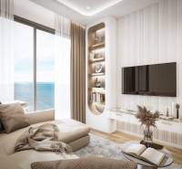 Living room in a 3-room apartment with a sea view, comfortable sofa, TV on the wall.