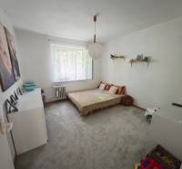 A children's room with a bed, wardrobe, and toys in a 2-room apartment.