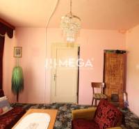Living room with a chandelier and a sofa in a family house.