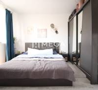 Bedroom in a 3-room apartment with a double bed, wardrobe, and dark curtains.