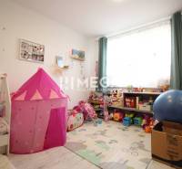 Children's room in a 3-room apartment with toys, a tent, and a window with shelves.