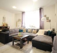 Living room in a three-room apartment with a sofa and decorations in a pleasant environment.