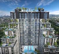 Apartment construction in Pattaya with rooftop terraces and pools amidst greenery.