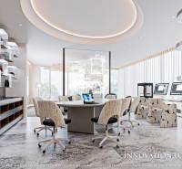 Interior of an office with a round table, computers, and modern lighting. Apartment construction.