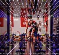 Fitness studio with exercise bikes and a projected screen under construction in an apartment building.