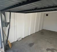 Open garage with a broom and a sign in Bratislava - Ružinov on Prístavná Street.