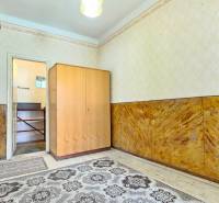 Interior with a wooden wardrobe, doors, and a carpet. A room suitable for living.