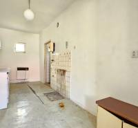 An older kitchen with simple furnishings, linoleum flooring. Properties - housing.