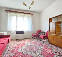 Living room with a red carpet, sofa set, and display cabinet. Real estate - housing.