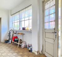 A bright hallway in the interior with vintage furniture and balcony doors. Real estate - housing.