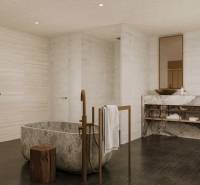 A family house bathroom with an oval stone bathtub and elegant sinks.