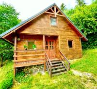 A wooden family house in Štefultov, surrounded by greenery, with a simple rural design.