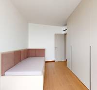 A room with a bed and a built-in wardrobe in a 4-room apartment.