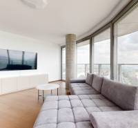 Living room in a 4-room apartment with a sofa, television, and panoramic view of the river.