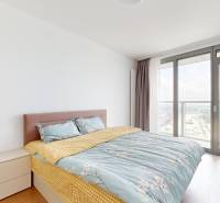 Bedroom in a 4-room apartment with a large window and a bed.