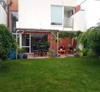 The garden of a family house on Brusnicova Street in Chorvátsky Grob with a terrace and greenery.