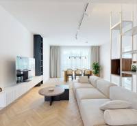Living room in a 3-room apartment with a sofa, television, and dining table.
