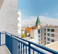 A view from the balcony of a 3-room apartment overlooking the church tower and the panorama of Bratislava.