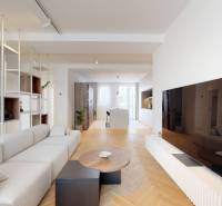 Living room with a long couch, television, and wooden floor in a 3-room apartment.