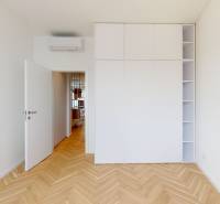 A view of a room with a white wardrobe and parquet flooring in a 3-room apartment.
