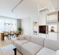 Living room of a three-room apartment with a sofa, dining table, and elegant curtains.