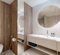 A bathroom in a 3-room apartment with wooden paneling, a mirror, and a double sink.