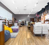Retail space with shelves full of textiles and colorful bean bags.