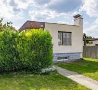 A family house on Mokráň záhon Street in Bratislava-Ružinov, surrounded by greenery and lawn.