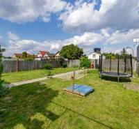The garden of a family house on Mokráň záhon in Bratislava-Ružinov with a lawn and a trampoline.