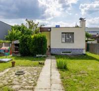 A family house on Mokráň Záhon in Bratislava - Ružinov with a well-maintained garden and trees.